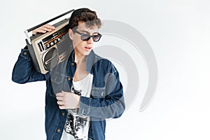 Handsome young man holding boombox