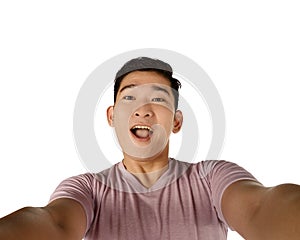 Handsome young man holding camera and making selfie