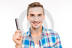 Handsome young man holding a comb