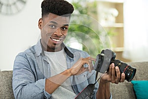 handsome young man holding photo camera