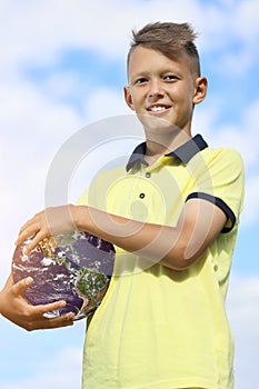 Handsome young man holding planet earth in his hands. Elements of this image furnished by NASA