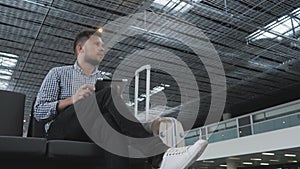 Handsome Young Man Holding Tablet PC And Working at The Airport, Technology, Travelling Concept