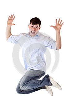 Handsome young man jumps in the air out of joy photo