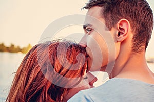 Handsome young man kissing his girlfriend