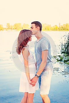 Handsome young man kissing his girlfriend