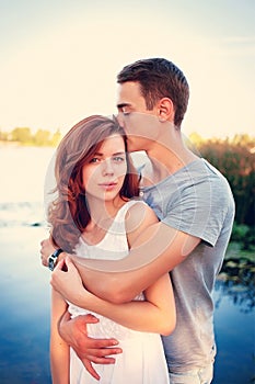 Handsome young man kissing his girlfriend