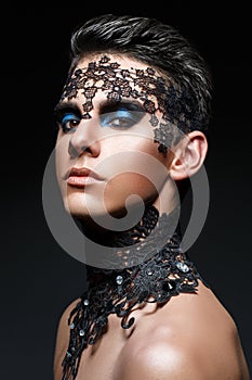 Handsome young man with lace on face
