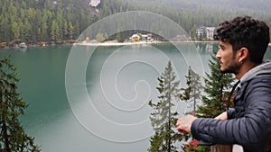 Handsome young man on a lake enjoying the view