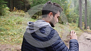 Handsome young man on a lake recording video with action camera