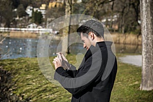 Handsome young man on a lake in a sunny day