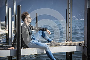 Handsome young man on lake in a sunny, peaceful