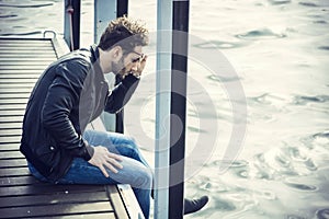 Handsome young man on lake in a sunny, peaceful