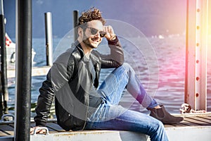 Handsome young man on lake in a sunny, peaceful