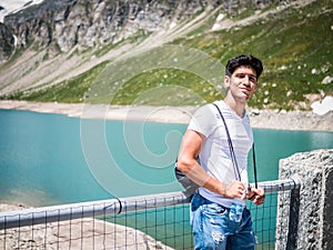 Handsome young man on a lake in a sunny, peaceful