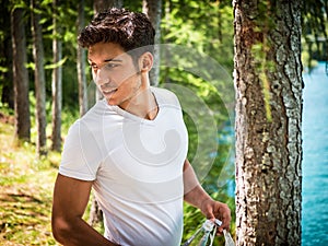 Handsome young man on a lake in a sunny, peaceful