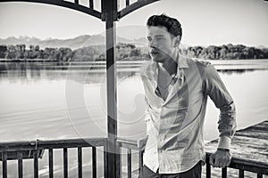 Handsome young man on a lake in a sunny, peaceful