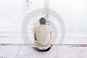 Handsome young man on lake in a sunny, peaceful day