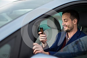 Handsome young man looking at his cellphone