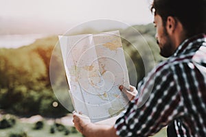 Handsome Young Man Looking at Paper Map Outdoors