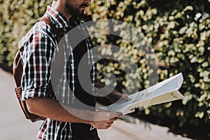 Handsome Young Man Looking at Paper Map Outdoors