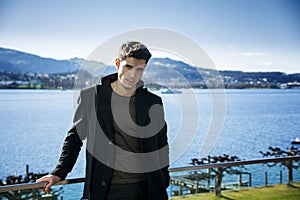 Handsome young man on Luzern lake's shore