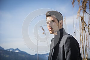 Handsome young man on Luzern lake's shore