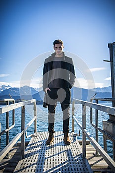 Handsome young man on Luzern lake`s shore