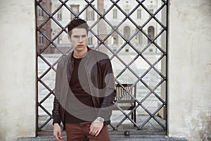 Handsome young man outside historical building in European city