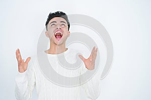 Handsome young man over white isolated background crazy and mad shouting and yelling with aggressive expression and arms raised