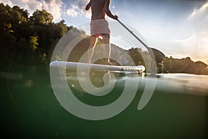 Handsome young man on a paddle board