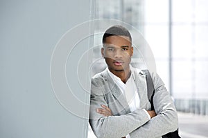 Handsome young man posing with bag at airport