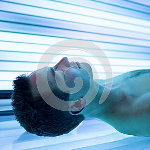 Handsome young man relaxing in a solarium