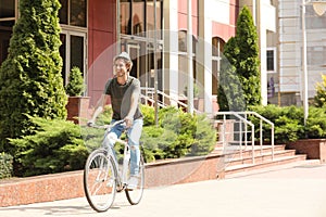 Handsome young man riding bicycle