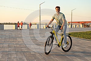 Handsome young man riding bicycle