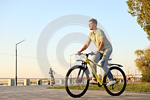 Handsome young man riding bicycle