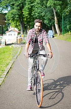 Handsome young man riding his bicycle