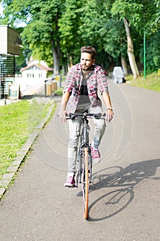 Handsome young man riding his bicycle
