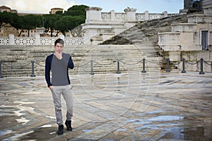 Handsome young man in Rome in front of Vittoriano monument