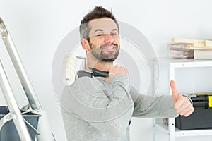 handsome young man rubbing down wall