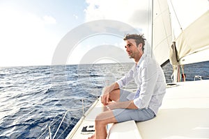 Handsome young man on sailing boat