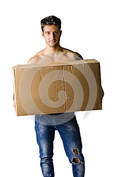 Handsome young man shirtless holding big cardboard box