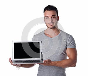 Handsome young man showing laptop computer