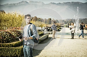 Handsome young man sightseeing in a park