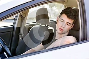 Handsome Young Man sleeping in a Car