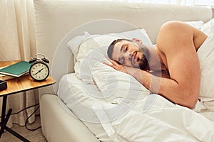 Handsome young man sleeping peacefully in bed