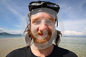 Handsome young man with smiley face during the snorkeling in the sea