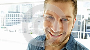 Handsome young man smiling at camera