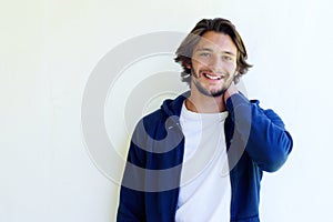 Handsome young man smiling with hand behind head