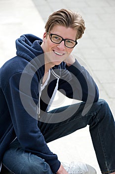 Handsome young man smiling outdoors