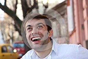 Handsome young man smiling outdoors